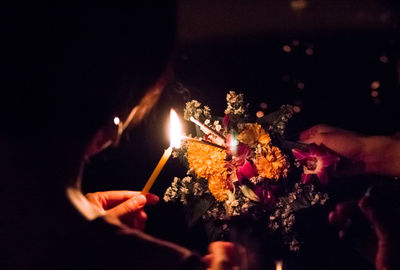 People holding burning fire