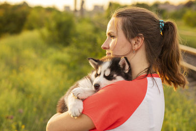 Close-up of young woman with dog