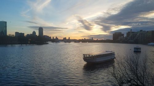 Nautical vessel on river against sky during sunset