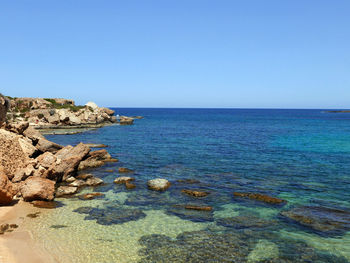 Scenic view of sea against clear blue sky