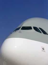 Low angle view of airbus a380 against clear blue sky