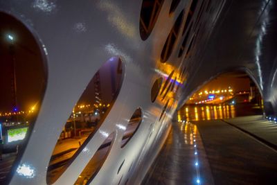 Illuminated bridge in city against sky at night