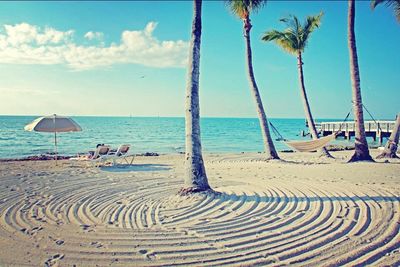 Scenic view of beach against blue sky