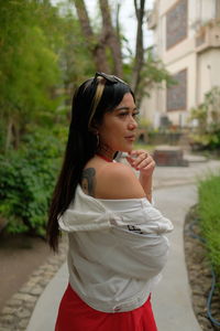 Rear view of woman standing against building