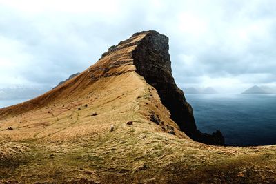 Rock formation on mountain against sky