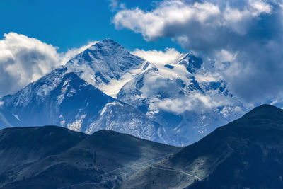 Scenic view of snowcapped mountains against sky