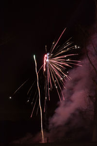 Low angle view of firework display at night