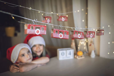 Cute brother and sister looking at christmas decoration