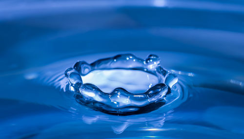 Close-up of water drop on blue surface