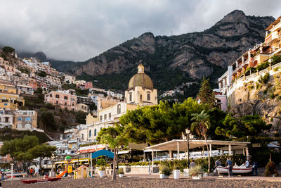 View of buildings in town against cloudy sky