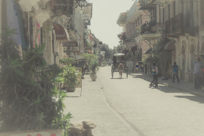 People walking on street in city