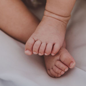 Low section of baby feet