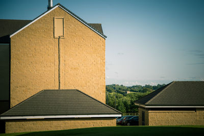 Exterior of house on field against sky