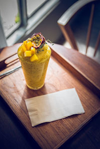 Close-up of hand holding drink on table