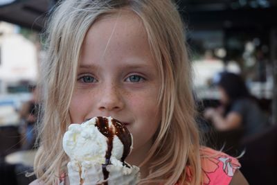 Close-up portrait of girl eating ice cream