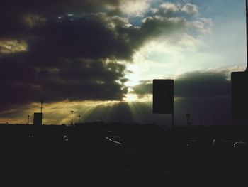 Buildings against cloudy sky at sunset