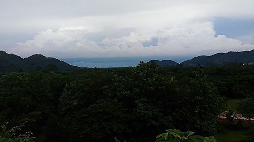 Scenic view of mountains against cloudy sky