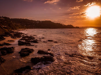 Scenic view of beach against sky during sunset