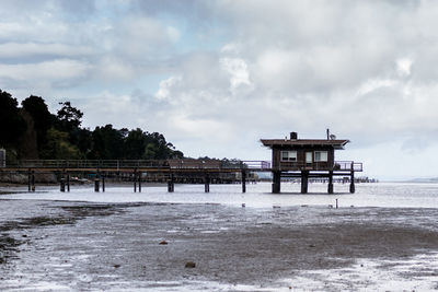 Lifeguard hut on beach against sky
