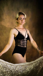 Portrait of young woman standing on rock