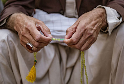 Midsection of man holding hands