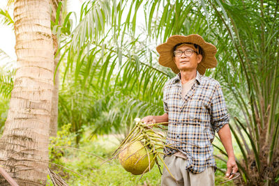 Smiling young woman standing in farm