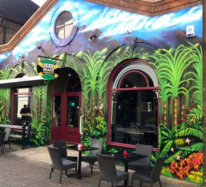 Empty chairs and tables in illuminated building