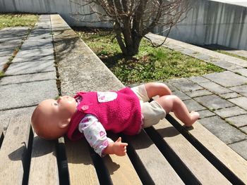 High angle view of girl lying on footpath