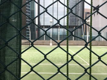 Full frame shot of chainlink fence against playing field