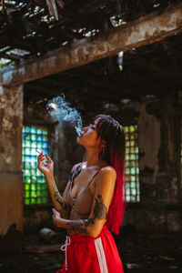 Young woman standing against the wall
