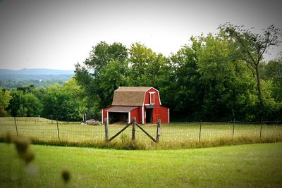 Lifeguard hut on field against sky