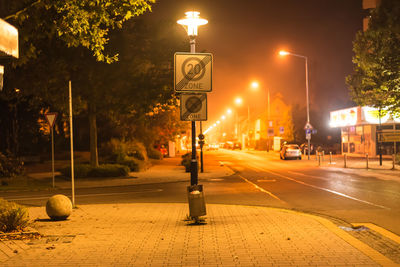Speed limit sign on gas light in city at night
