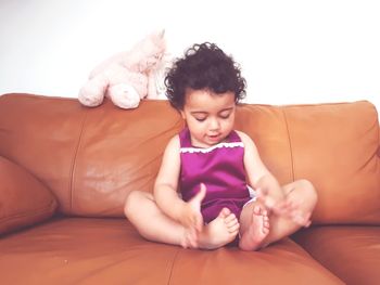 Cute boy lying on sofa at home