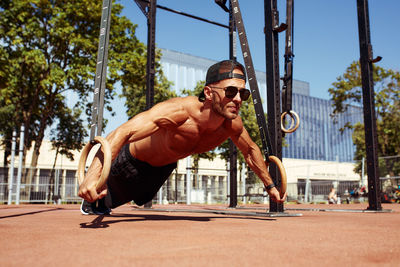 Low angle view of man exercising on field