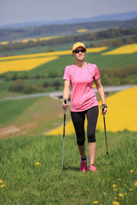 Full length of woman hiking on land against sky