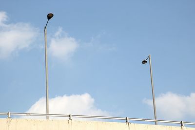 Low angle view of street light against blue sky