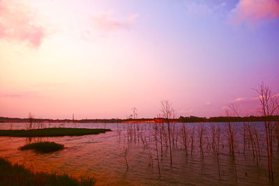 Bridge over river against sky during sunset