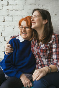 Happy adult daughter embracing mother