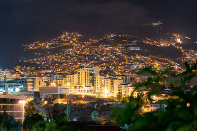 High angle view of illuminated buildings in city at night