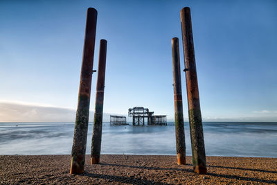 The ruins of the west pier at brighton looking out to sea from the pebble beach