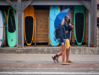 Full length side view of men standing at city