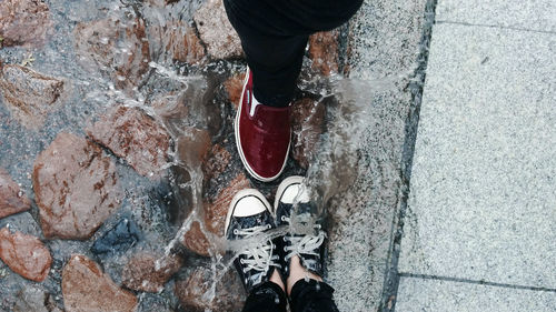 Low section of person standing on tiled floor