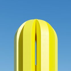 Low angle view of yellow structure against blue sky