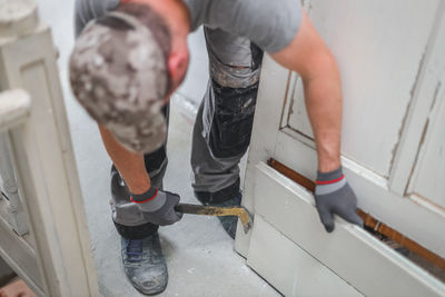 A young man works with a crowbar.