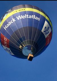 Low angle view of hot air balloon against blue sky