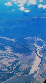 Aerial view of landscape against blue sky