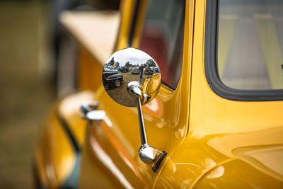 Close-up of side-view mirror on vintage car