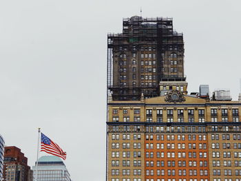 Low angle view of tall buildings against clear sky