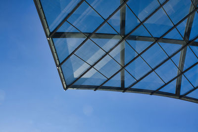 Low angle view of metallic structure against blue sky