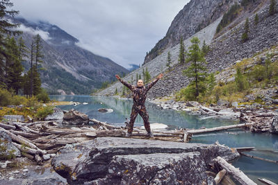 Man standing on rocks by mountain